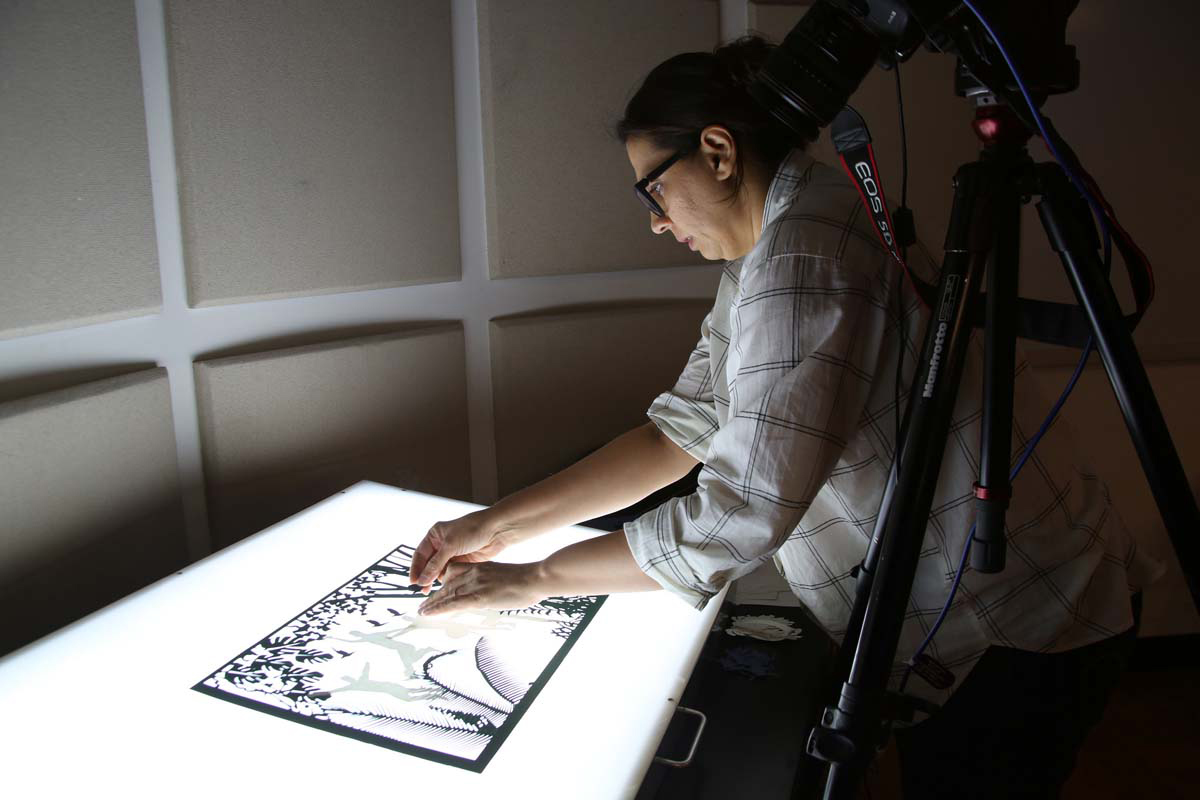 a person working on an animation with a light board